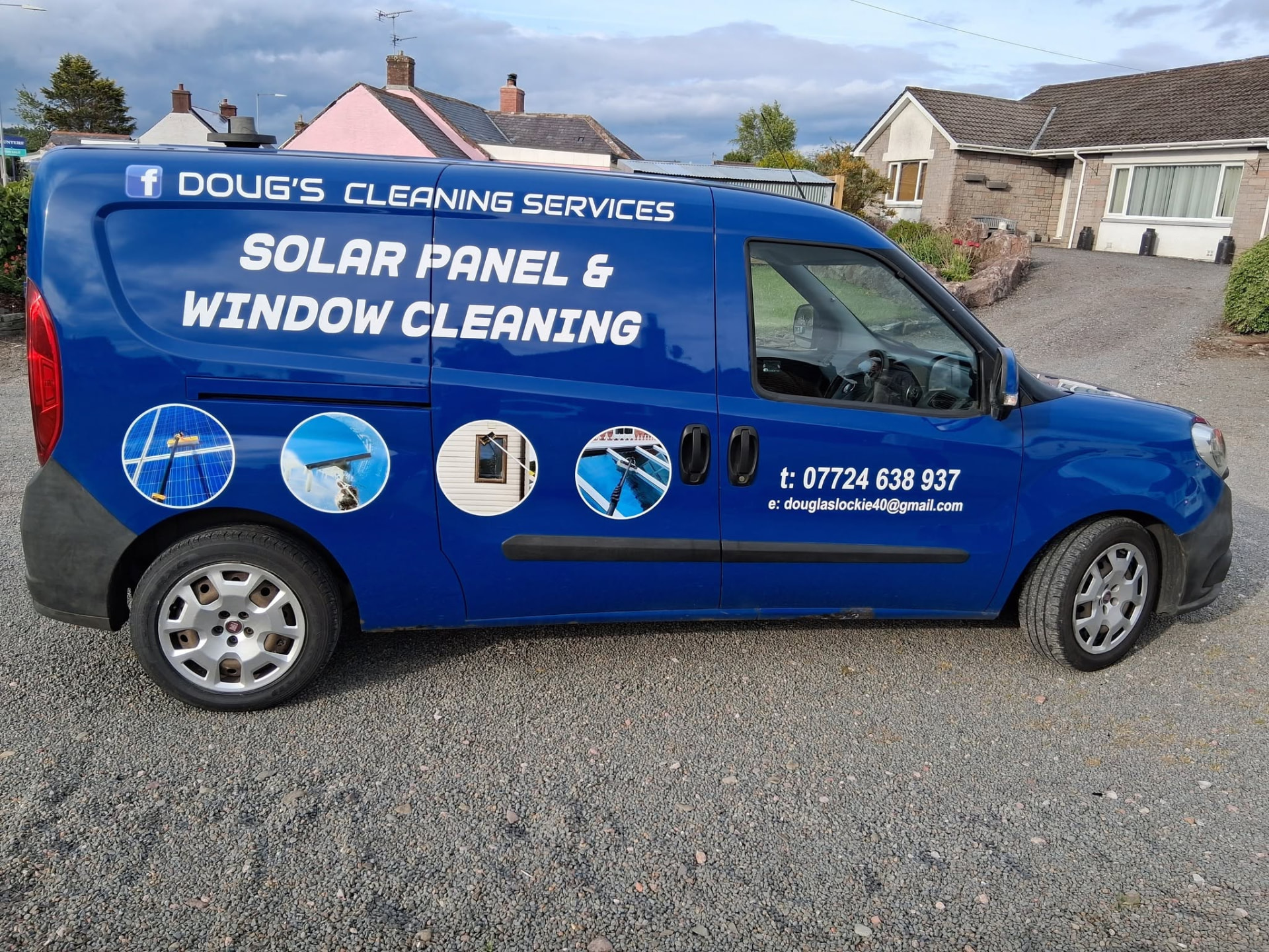 Driver side of the Doug's Cleaning Services van showing solar panel and window cleaning branding